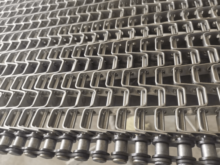 What is the best method for cleaning a flat wire conveyor belt?