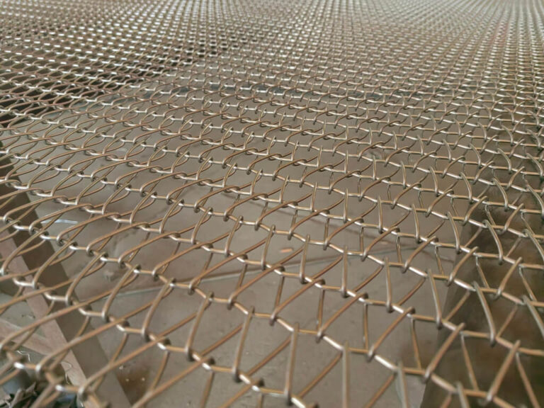 What are the common causes of slippage in stainless steel mesh conveyor belts?